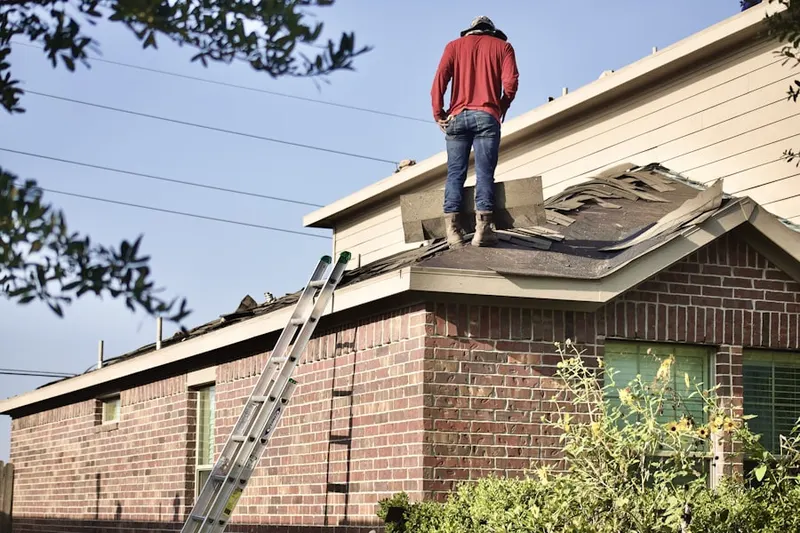 Professional roofer working on a residential roof in Cleveland Heights